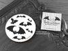 Gothic Bats Coaster featuring my original pen and ink illustration of gothic bats, front view alongside one of my branded cards. Made in the UK. Design and illustration © Nicola L Robinson | Teeth and Claws.