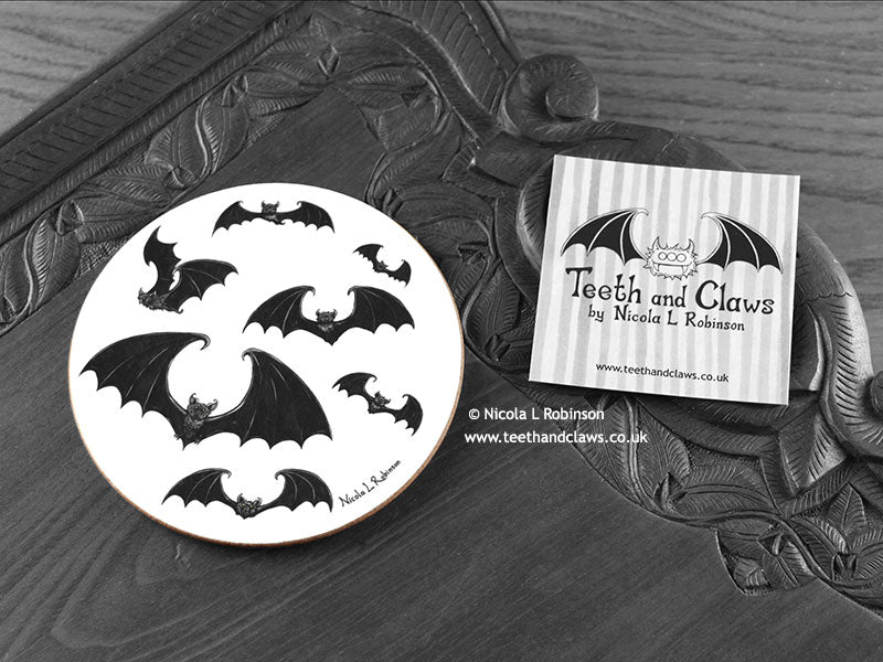 Gothic Bats Coaster featuring my original pen and ink illustration of gothic bats, front view alongside one of my branded cards. Made in the UK. Design and illustration © Nicola L Robinson | Teeth and Claws.