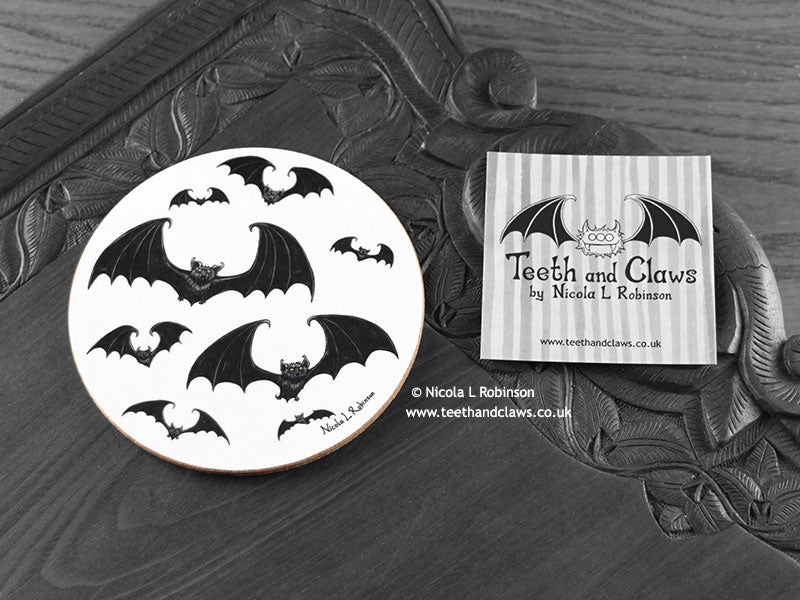 Gothic Bats Coaster featuring my original pen and ink illustration of gothic bats, front view alongside one of my branded cards. Made in the UK. Design and illustration © Nicola L Robinson | Teeth and Claws.