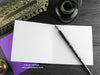 Gothic bats greeting card, shown open and flat with blank inside, on a purple envelope, alongside vintage Victorian pen and writing desk accessories. Design and illustration © Nicola L Robinson | Teeth and Claws