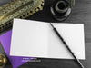 Gothic bats greeting card, shown open and flat with blank inside, on a purple envelope, alongside vintage Victorian pen and writing desk accessories. Design and illustration © Nicola L Robinson | Teeth and Claws