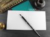 Grey Persian cat greeting card, shown open and flat with blank inside, on a teal envelope, alongside vintage Victorian pen and writing desk accessories. Design and illustration © Nicola L Robinson | Teeth and Claws