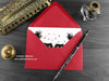 Black Persian cats love card, shown lying flat, with my original pen and ink illustration of black Persian cats, inside an open red envelope. With vintage Victorian pen and writing desk accessories. Design and illustration © Nicola L Robinson | Teeth and Claws