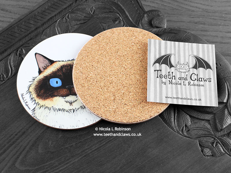 Birman Cat Coaster featuring my original pen and ink illustration of a Birman cat, also back view showing the cork backing, alongside one of my branded cards. Made in the UK. Design and illustration © Nicola L Robinson | Teeth and Claws.