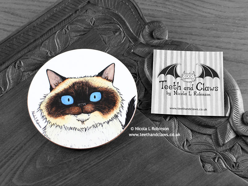 Birman Cat Coaster featuring my original pen and ink illustration of a Birman cat face, front view alongside one of my branded cards. Made in the UK. Design and illustration © Nicola L Robinson | Teeth and Claws.