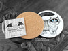 Ragdoll Cat Coaster featuring my original pen and ink illustration of a Ragdoll cat, back view showing the cork backing, alongside one of my branded cards. Made in the UK. Design and illustration © Nicola L Robinson | Teeth and Claws.