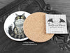Maine Coon Cat Coaster featuring my original pen and ink illustration of a Maine Coon cat, back view showing the cork backing, alongside one of my branded cards. Made in the UK. Design and illustration © Nicola L Robinson | Teeth and Claws.