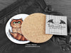 Persian Cat Coaster featuring my original pen and ink illustration of a ginger Persian cat, back view showing the cork backing, alongside one of my branded cards. Made in the UK. Design and illustration © Nicola L Robinson | Teeth and Claws.
