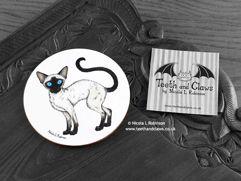 Siamese Cat Coaster featuring my original pen and ink illustration of a Siamese cat, front view alongside one of my branded cards. Made in the UK. Design and illustration © Nicola L Robinson | Teeth and Claws.