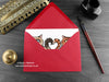 Cat love card, shown lying flat, with my original pen and ink illustration of two cats, inside an open red envelope. With vintage Victorian pen and writing desk accessories. Design and illustration © Nicola L Robinson | Teeth and Claws