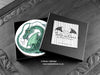 Set of four of my dragon coasters featuring my original pen and ink dragon illustrations, front view in an open black gift box with card. Made in the UK. Design and illustration © Nicola L Robinson | Teeth and Claws.
