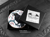 Set of four of my crow coasters featuring my original pen and ink crow illustrations, front view in open black gift box with lid removed, with coasters inside, and card. Made in the UK. Design and illustration © Nicola L Robinson | Teeth and Claws.