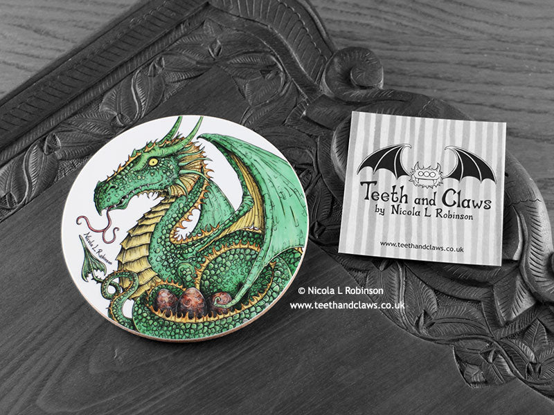 Green Dragon Coaster featuring my original pen and ink illustration of a green dragon, front view alongside one of my branded cards. Made in the UK. Design and illustration © Nicola L Robinson | Teeth and Claws.