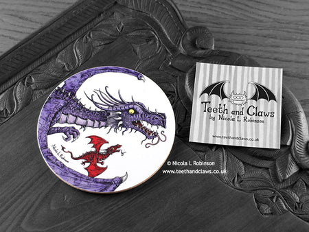 Purple Dragon Coaster featuring my original pen and ink illustration of a purple dragon, front view alongside one of my branded cards. Made in the UK. Design and illustration © Nicola L Robinson | Teeth and Claws.