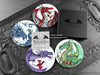 Set of four of my dragon coasters featuring my original pen and ink dragon illustrations, front view alongside a black gift box and card. Made in the UK. Design and illustration © Nicola L Robinson | Teeth and Claws.