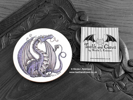 Lilac Dragon Coaster featuring my original pen and ink illustration of a purple dragon, front view alongside one of my branded cards. Made in the UK. Design and illustration © Nicola L Robinson | Teeth and Claws.