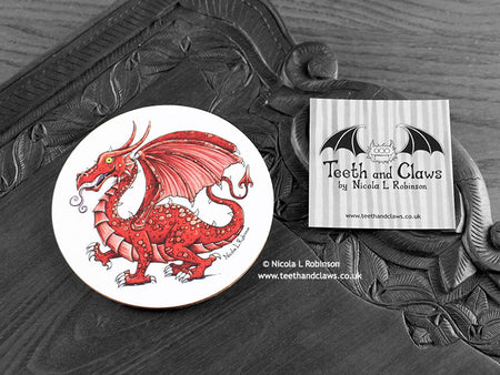 Welsh Dragon Coaster featuring my original pen and ink illustration of a Welsh dragon, front view alongside one of my branded cards. Made in the UK. Design and illustration © Nicola L Robinson | Teeth and Claws.