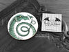 Green Dragon Coaster featuring my original pen and ink illustration of a green dragon, front view alongside one of my branded cards. Made in the UK. Design and illustration © Nicola L Robinson | Teeth and Claws.