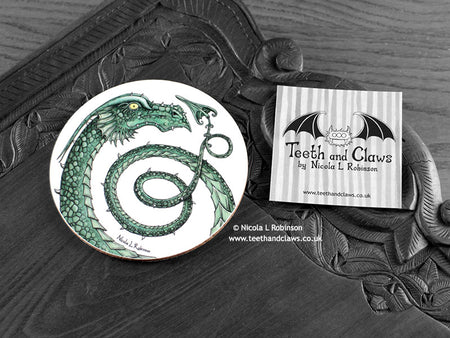 Green Dragon Coaster featuring my original pen and ink illustration of a green dragon, front view alongside one of my branded cards. Made in the UK. Design and illustration © Nicola L Robinson | Teeth and Claws.