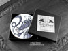 Set of four of my dragon coasters featuring my original pen and ink dragon illustrations, front view in an open black gift box with card. Made in the UK. Design and illustration © Nicola L Robinson | Teeth and Claws.
