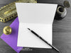 Spider birthday card, shown open and flat with blank inside, on a purple envelope, alongside vintage Victorian pen and writing desk accessories. Design and illustration © Nicola L Robinson | Teeth and Claws