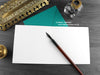 Cat couple greeting card, shown open and flat with blank inside, on a teal envelope, alongside vintage Victorian pen and writing desk accessories. Design and illustration © Nicola L Robinson | Teeth and Claws