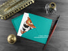 Cat couple greeting card, shown lying flat, with my original pen and ink illustration of two cats, inside an open teal envelope. With vintage Victorian pen and writing desk accessories. Design and illustration © Nicola L Robinson | Teeth and Claws