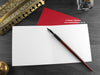Cats Christmas card, shown open and flat with blank inside, on a red envelope, alongside vintage Victorian pen and writing desk accessories. Design and illustration © Nicola L Robinson | Teeth and Claws