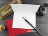 Wolves love card, shown open and flat with blank inside, on a red envelope, alongside vintage Victorian pen and writing desk accessories. Design and illustration © Nicola L Robinson | Teeth and Claws