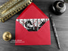 Wolves love card, shown lying flat, with my original pen and ink illustration of two wolves, inside an open red envelope. With vintage Victorian pen and writing desk accessories. Design and illustration © Nicola L Robinson | Teeth and Claws