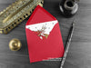Dragon Christmas card, shown lying flat, with my original pen and ink illustration of a festive red dragon, inside an open red envelope. With vintage Victorian pen and writing desk accessories. Design and illustration © Nicola L Robinson | Teeth and Claws