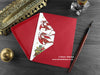 Dragon Christmas card, shown lying flat, with my original pen and ink illustration of festive dragons, inside an open red envelope. With vintage Victorian pen and writing desk accessories. Design and illustration © Nicola L Robinson | Teeth and Claws