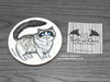 Ragdoll Cat Coaster featuring my original pen and ink illustration of a Ragdoll cat, front view alongside one of my branded cards. Made in the UK. Design and illustration © Nicola L Robinson | Teeth and Claws.