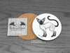 Siamese Cat Coaster featuring my original pen and ink illustration of a Siamese cat, back view showing the cork backing, alongside one of my branded cards. Made in the UK. Design and illustration © Nicola L Robinson | Teeth and Claws.