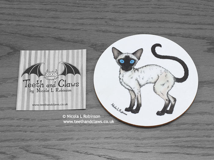 Siamese Cat Coaster featuring my original pen and ink illustration of a Siamese cat, front view alongside one of my branded cards. Made in the UK. Design and illustration © Nicola L Robinson | Teeth and Claws.